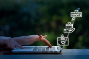 Woman using laptop with donate icons